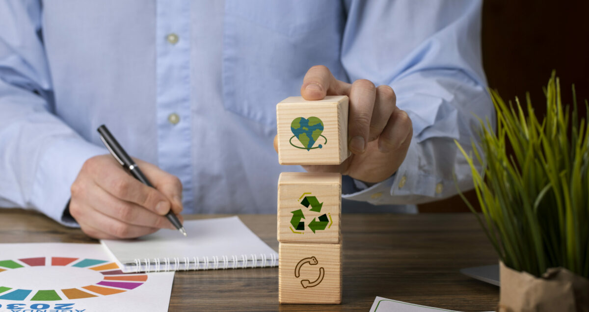 a girl holding sustainability blocks